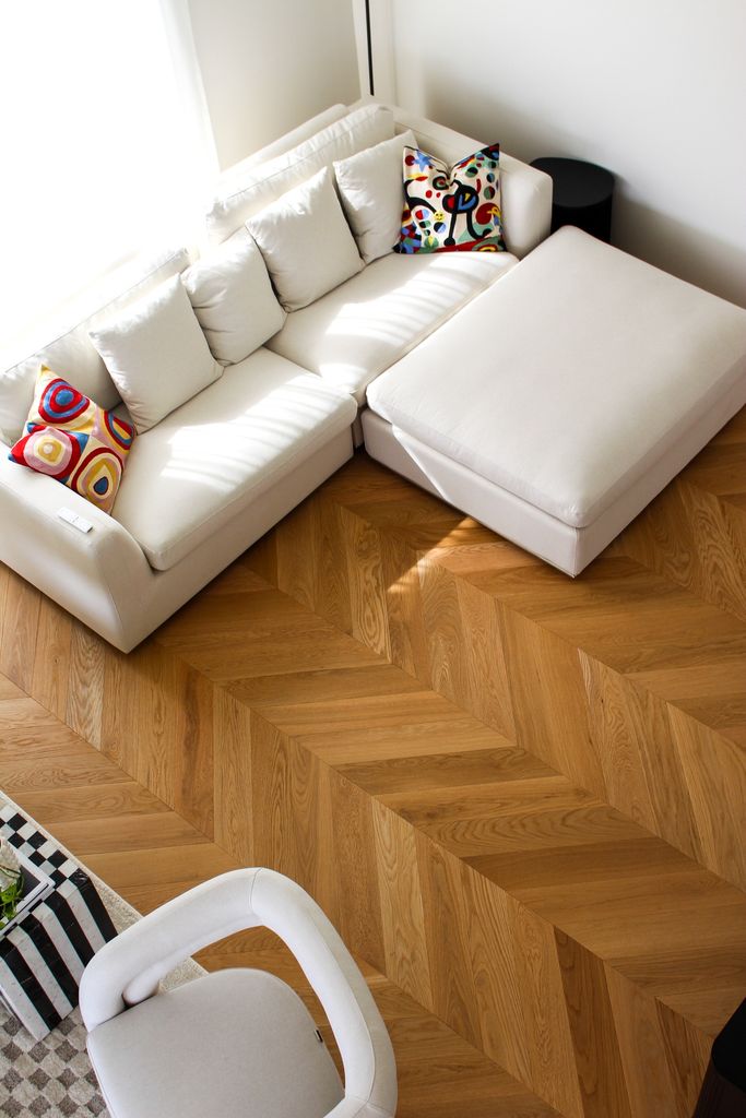 Herringbone hardwood floor in a bright living room