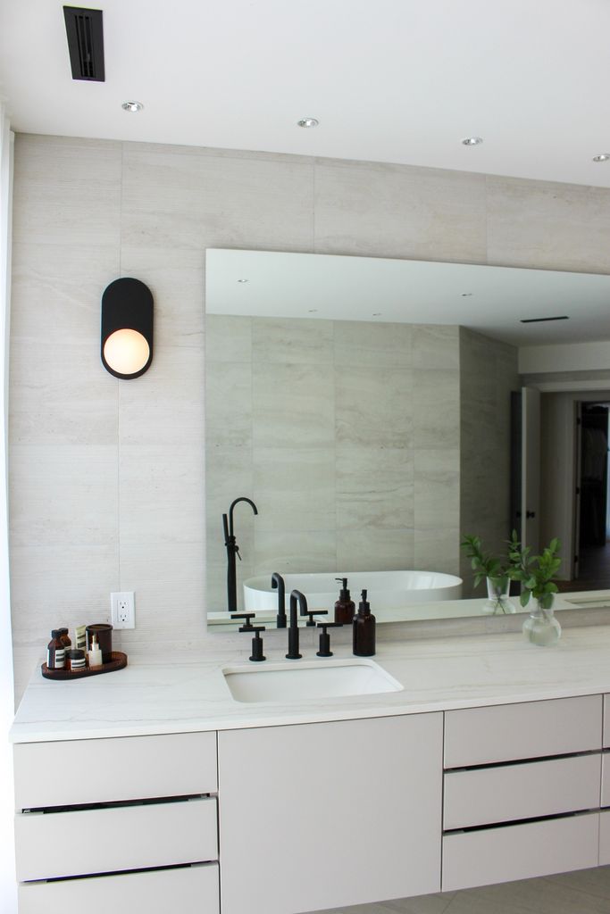 Bathroom with ceramic wall tiles and a white vanity