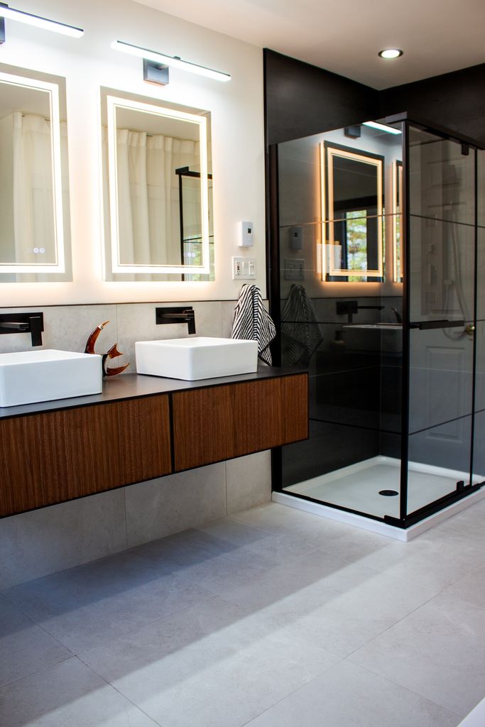 Bathroom with ceramic flooring, glass shower and wood vanity
